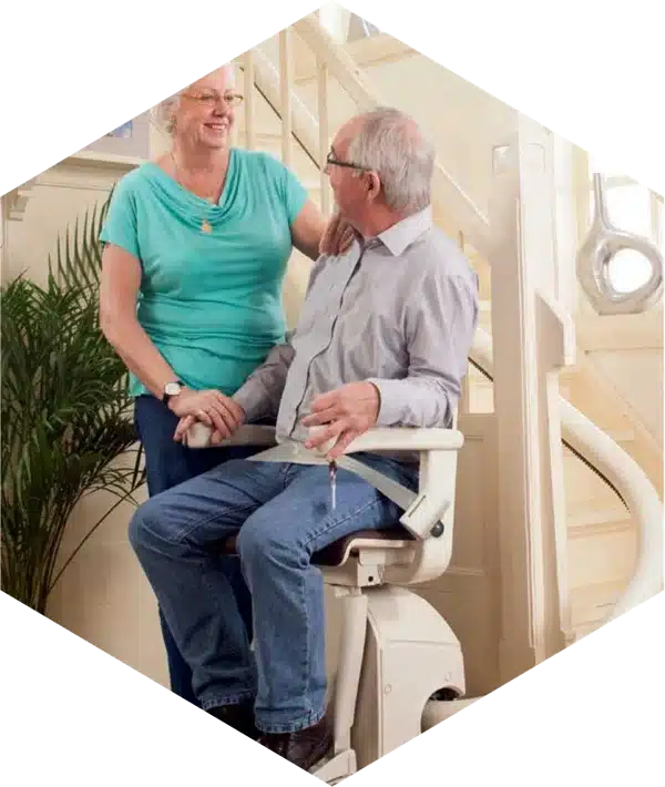 Veteran using a stairlift at home with family support