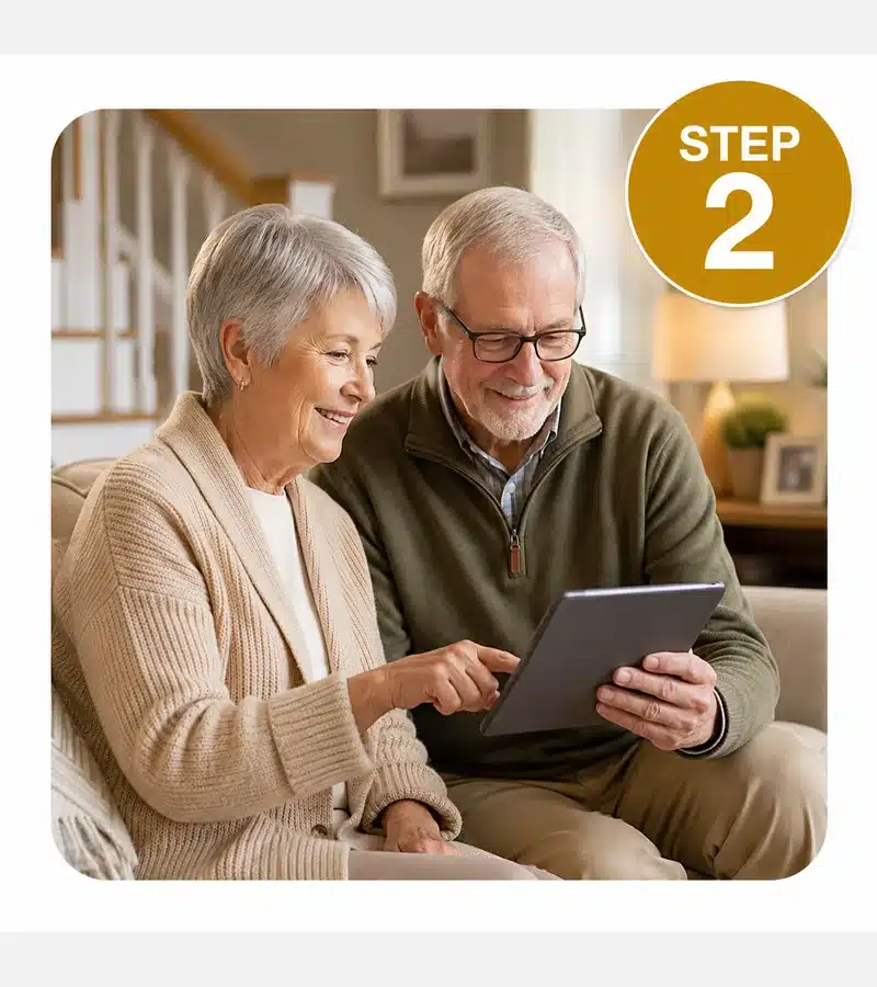 Step 2: Review Your Stair Lift Options Older couple reviewing stair lift information on a tablet with a gold Step 2 badge